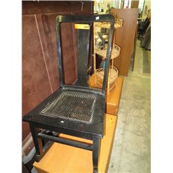 Black rocking chair with a rattan seat