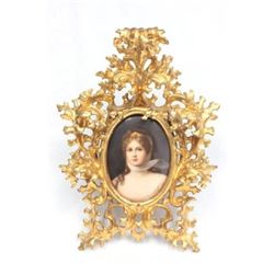 Gilt carved frame with porcelain plaque