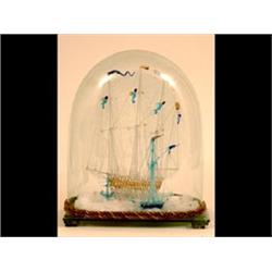 A Nailsea Style Glass Model, of a three masted vessel, the rigging  with three sailors, under a g...