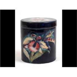 A Moorcroft Cylindrical Jar and Cover, decorated orchids, 9.5cm See illustration £200-300...