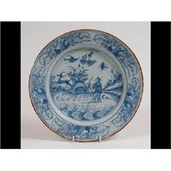 An 18th Century Blue and White Delft Plate, the centre decorated a  house, and a huntsman having...