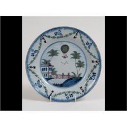 A Late 18th Century Delft Plate, decorated in underglaze blue and  green a balloon near a house,...