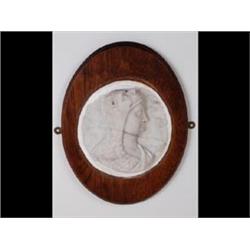 An 18th Century Marble Plaque, carved in high relief a bust of a  gentleman, wearing a lion fleec...