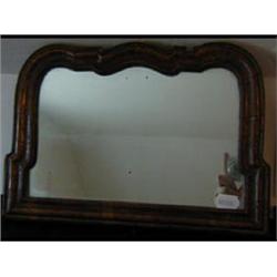 An 18th Century Mirror, veneered in walnut, having a shaped arched  top (later plate), 26 x 37cm...