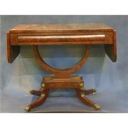 A Regency mahogany sofa table with crossbanded top, fitted a frieze drawer and raised on a U shap...
