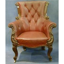 A Victorian carved rosewood armchair with show frame, the seat upholstered in red buttoned rexine...