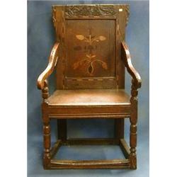 An 18th Century carved and inlaid oak Wainscot chair with solid seat on turned and block supports...