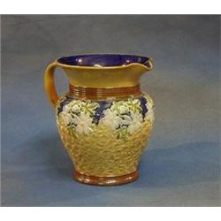 A Doulton Lambeth salt glazed jug with floral decoration, the base impressed Doulton Lambeth Engl...