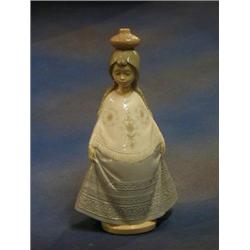 A Nao figure of a standing girl with pot on her head, the base marked Nao 346P 11" £30-50...