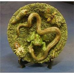 A Portuguese Majolica pottery plate decorated a snake attacking a frog with butterfly and 3 other...