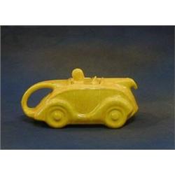 A Sadler yellow glazed pottery teapot in the form of a racing car (2 slight chips to rim) £30-50...