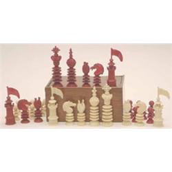 A mid 19th century English chess set by Lund, natural and red-stained ivory, finely carved and tu...