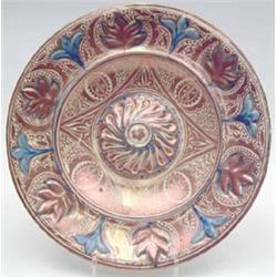 An Hispano Moresque pink lustre charger concentrically painted with floral motifs highlighted in...