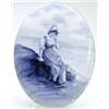 Image 1 : A Royal Doulton oval earthenware plaque painted with a fisher girl seated with basket in blue, 14...