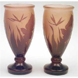 A pair of cameo glass vases acid etched with dragonflies and irises in amethyst against a paler g...