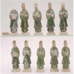 A set of 10 green glazed figures of attendants, each standing holding different objects including...