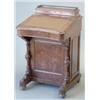 Image 1 : A Victorian figured walnut davenport with stationery compartment, concave slope and side door enc...