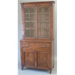 A Regency mahogany secretaire bookcase with ebony stringing, moulded cornice and two astragal gla...