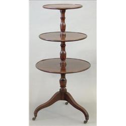 A George III mahogany dumb waiter with 3 dished circular tiers and slender baluster stem, on down...