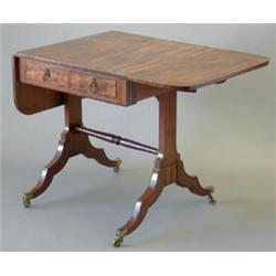 A small Regency mahogany sofa table with ebony stringing, D shaped flaps and 2 frieze drawers, on...