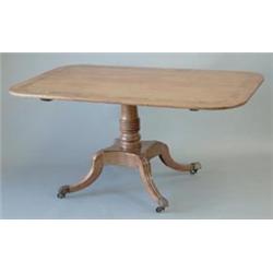 A Regency cross banded mahogany breakfast table with rounded rectangular tilt top and ring turned...
