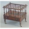 Image 1 : A Victorian rosewood canterbury with spindle divisions and base drawer on turned legs, fitted bra...
