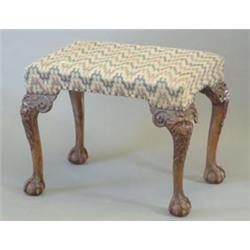 A Victorian carved mahogany dressing stool, with geometric upholstered seat and cabriole legs wit...