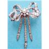 Image 1 : A late Victorian gold and silver diamond set tied ribbon brooch with central flowerhead cluster a...