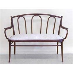 THONET BENTWOOD SETTEE Austrian. Late 19th Century. The slightly arched cresting rail above three...