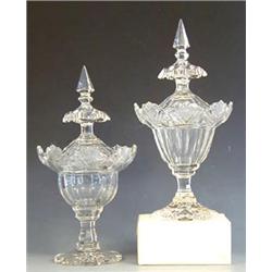 PAIR OF CUT GLASS URNS AND COVERS Probably Irish. 19th Century. Each with paneled body, faceted s...