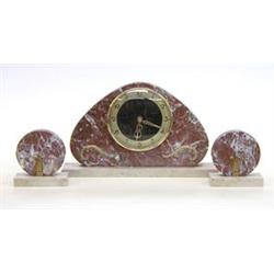 THREE PIECE ART DECO MARBLE CLOCK GARNITURE European. Circa 1930. The shaped marble plaque center...