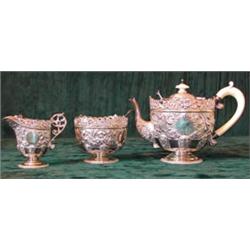 An ornate hallmarked silver teaset with silver gilt interior, London 1898...