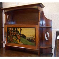 Liberty style walnut hanging cupboard enclosed by a panelled door having stained polychrome decor...