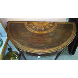 George III mahogany demi lune fold-over top card table, crossbanded and with inlaid flowerhead pa...