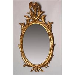 George III oval wall mirror within a carved wood and gilt gesso frame having eagle surmount, 3'6"...