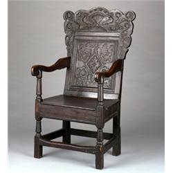 17th Century oak joined arm chair, the crest with central urn of flowers flanked by a pair of bir...