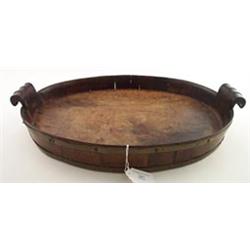 George III mahogany oval tray having two carved scroll handles and brass bound stave gallery, 1'7...