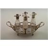 Image 1 : George III two handled boat shaped four division cruet stand fitted with four facet cut bottles o...