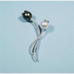 An 18kt gold, pearl and diamond brooch. A bla...
