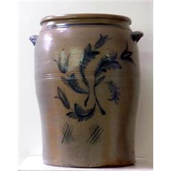 High stoneware crock. Decorated with four stylized tulips on front and cross etching. Note hairl...