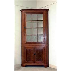 Two piece walnut corner cupboard. One drawer above with twelve lights and two blind doors below....