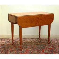 Figured cherry Sheraton Pembroke table. Dovetailed drawer, reeded legs, cut corner leaves, and a...