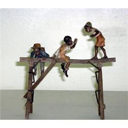 Austrian bronze pen holder. Decorated with three black boys playing on beam. $1200-1800...