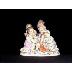 Meissen figure of four cherubs gathered around a fire. Note damage to fingers of one and restora...