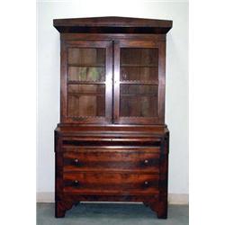 Empire walnut and mahogany veneer secretary. Two glass doors above and three drawers below. Circ...