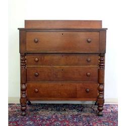 American Empire cherry chest of drawers. One large over three graduated drawers. Half columns an...