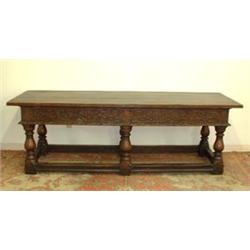 Large oak hall or library table. Heavily carved skirt with dragons. Suppoted by six vase turned...