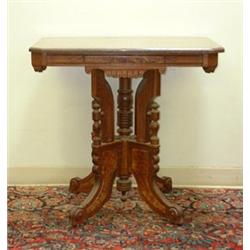 Pink fossil-marble-topped Victorian lamp table. Eastlake style with burl panels and decorative t...