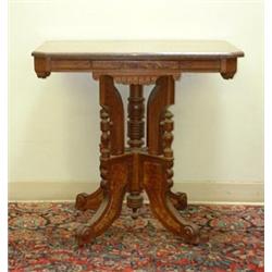 Pink fossil-marble-topped Victorian lamp table. Eastlake style with burl panels and decorative t...