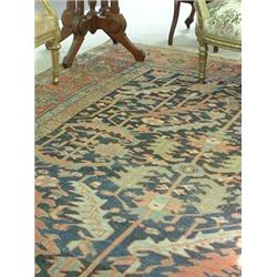 Oriental rug, stylized geometric florals on a blue field. Predominent colors are blues, green an...